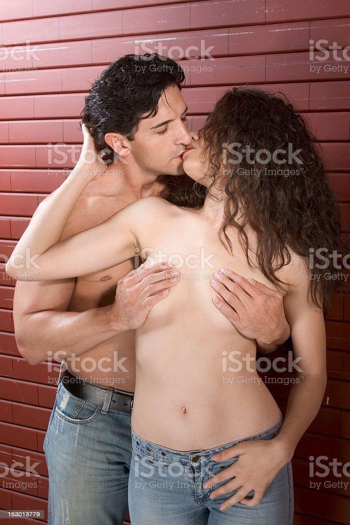 Man kissing naked woman